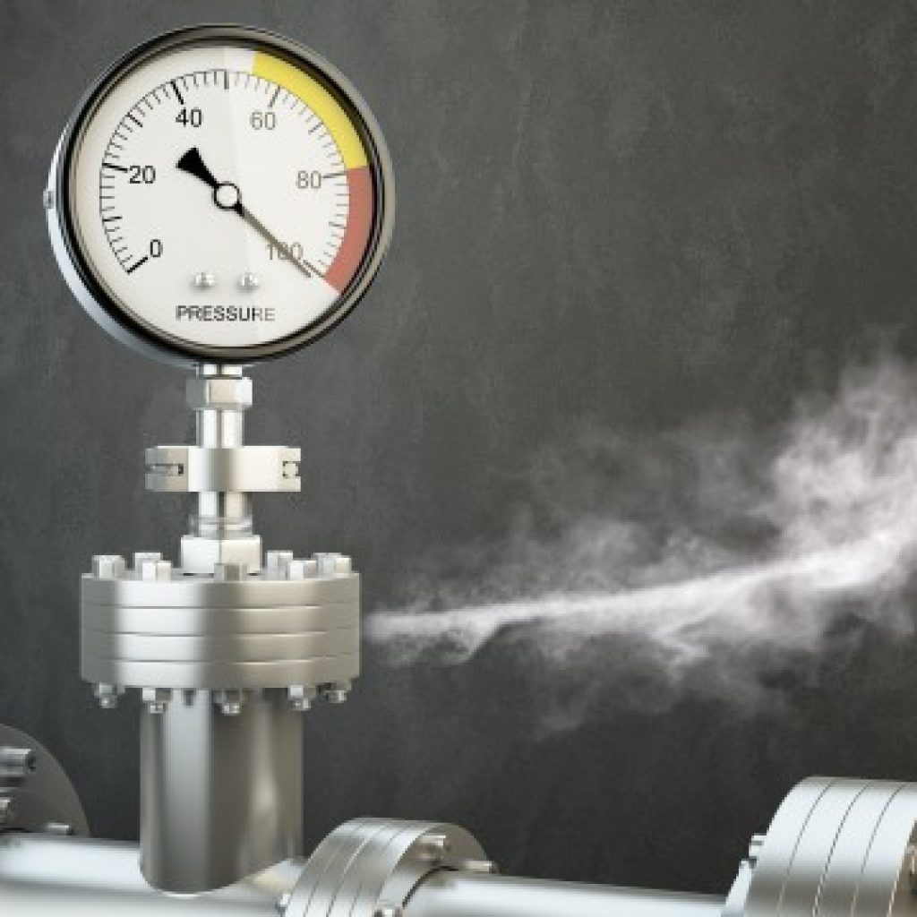 Manometer attached to a water heater with smoke rising, signaling a critical issue requiring immediate emergency appliance repair