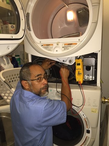 All Area Appliance professional technician inspecting and repairing a dryer, addressing signs your dryer needs repair